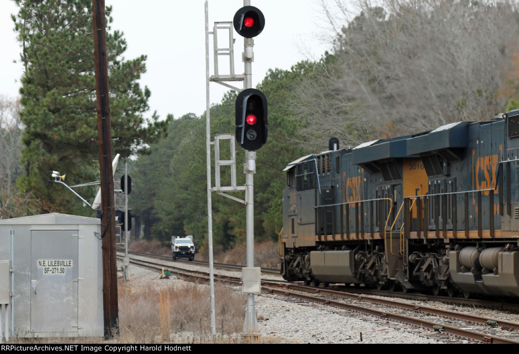 CSX 3016 leads a southbound train to a meet with a hi rail truck